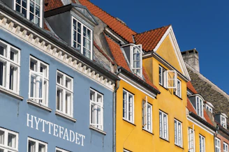 a row of colorful buildings with white windows