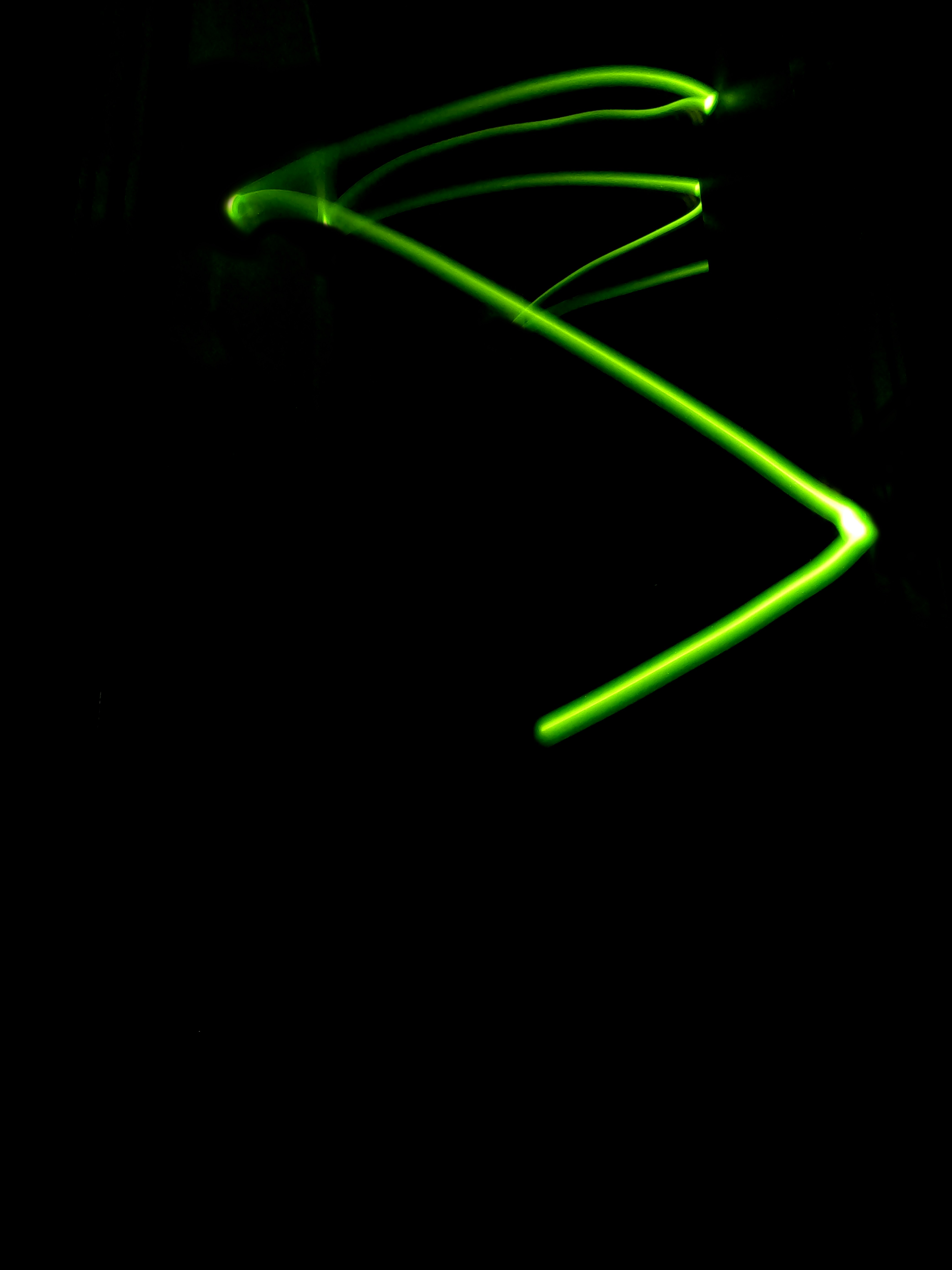 a black background with a green light in the middle of it
