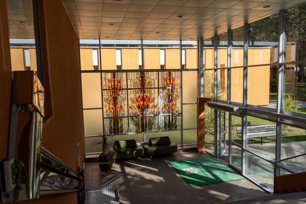 a room with a lot of windows and a rug on the floor