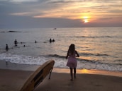 A beach scene with a light, breezy dress fluttering in the wind against a sunset backdrop.