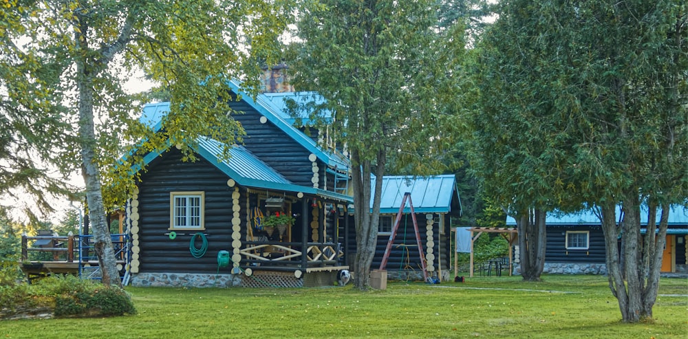 a small log cabin with a blue roof