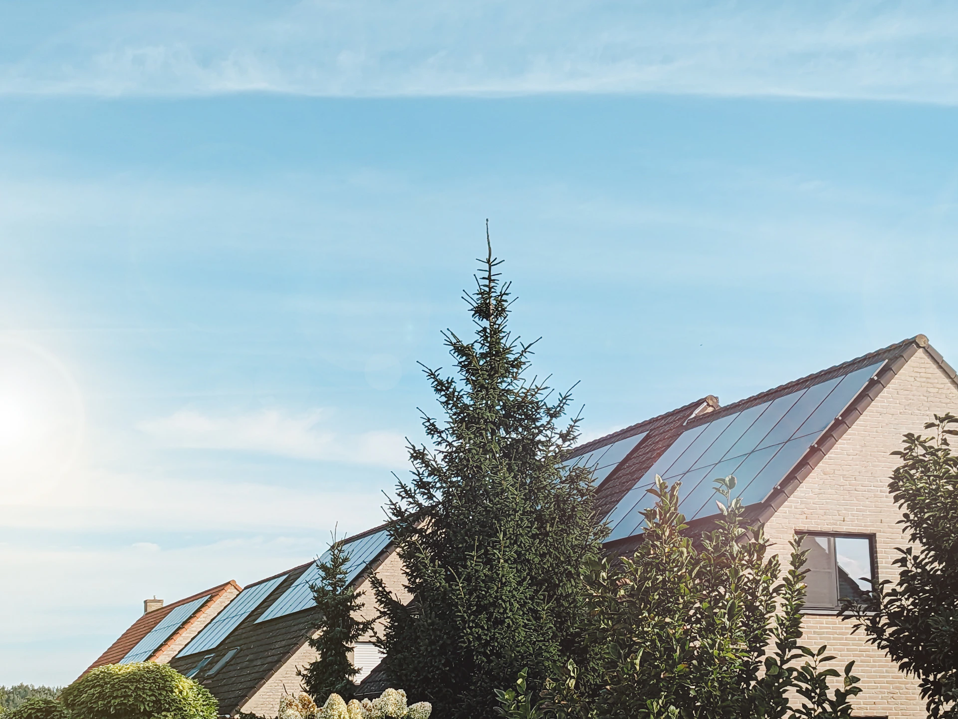 a row of houses with solar panels on the roof