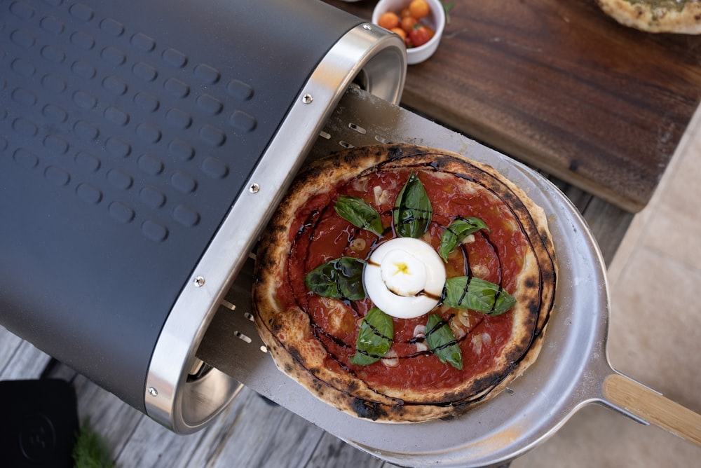 a pizza sitting on top of a metal pan