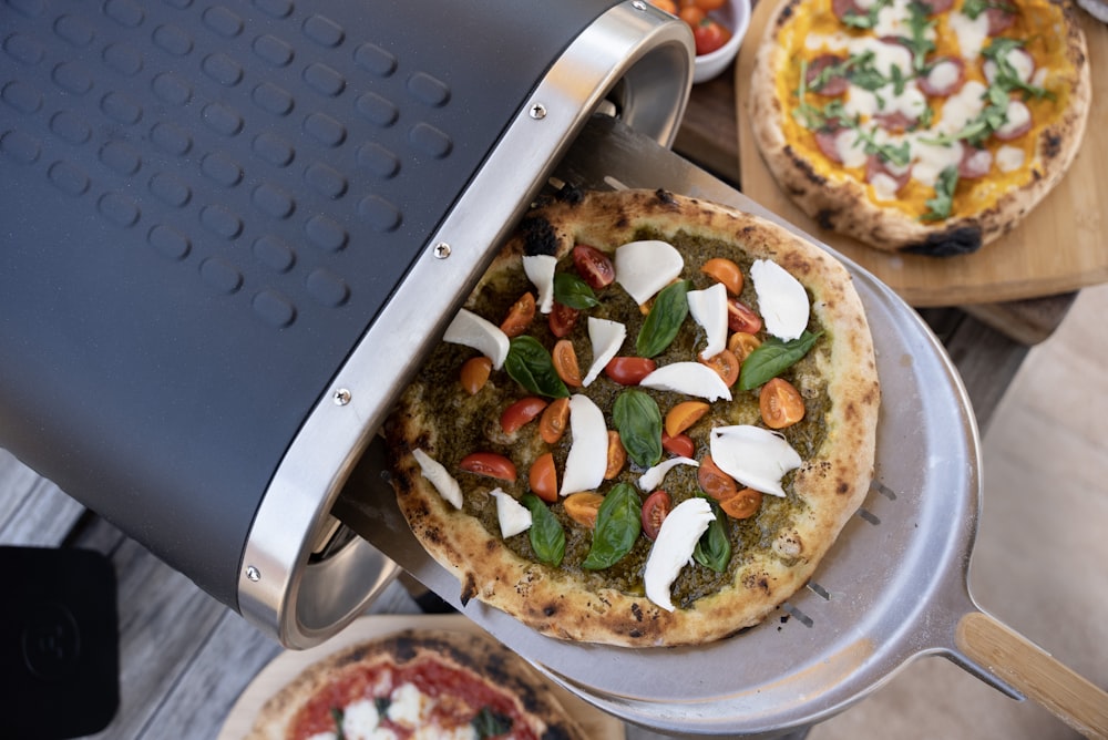 a couple of pizzas sitting on top of pans