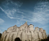 A detailed medieval fortress wall with banners fluttering in the wind.