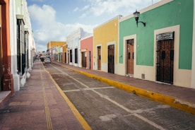 a street lined with brightly colored buildings on a cloudy day
