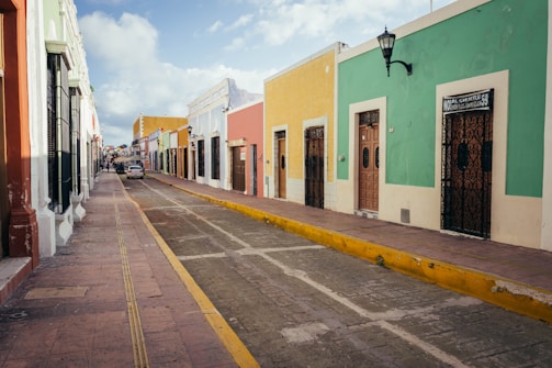 a street lined with brightly colored buildings on a cloudy day