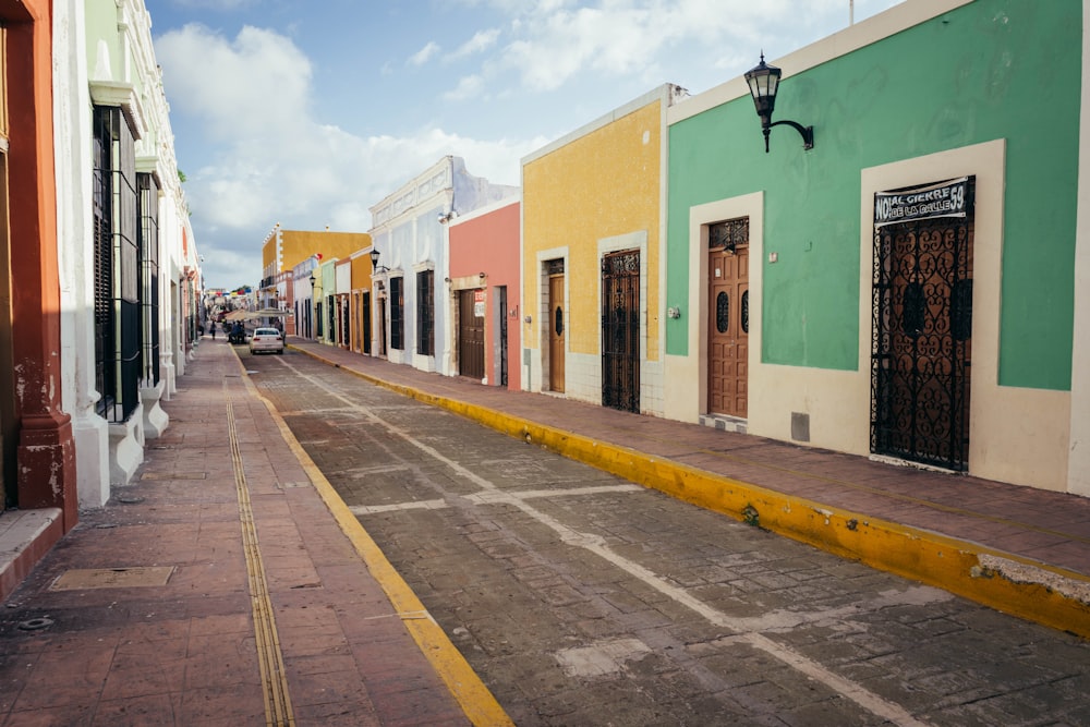 a street lined with brightly colored buildings on a cloudy day