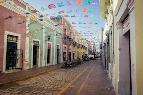 a street lined with colorful buildings and flags
