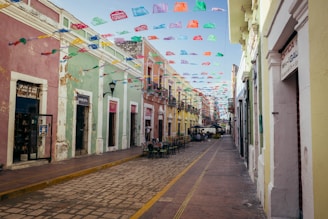 a street lined with colorful buildings and flags