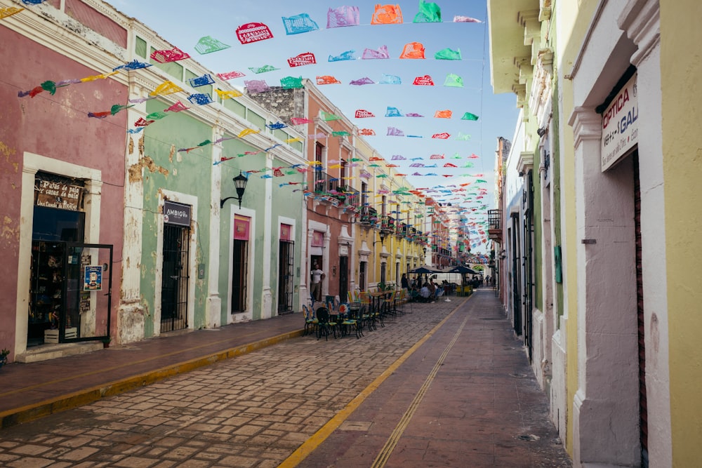 a street lined with colorful buildings and flags