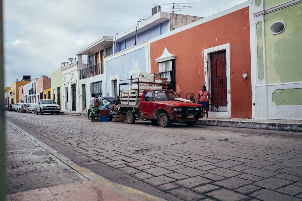 a red truck parked on the side of a road