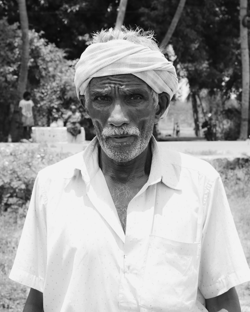 a black and white photo of a man with a turban