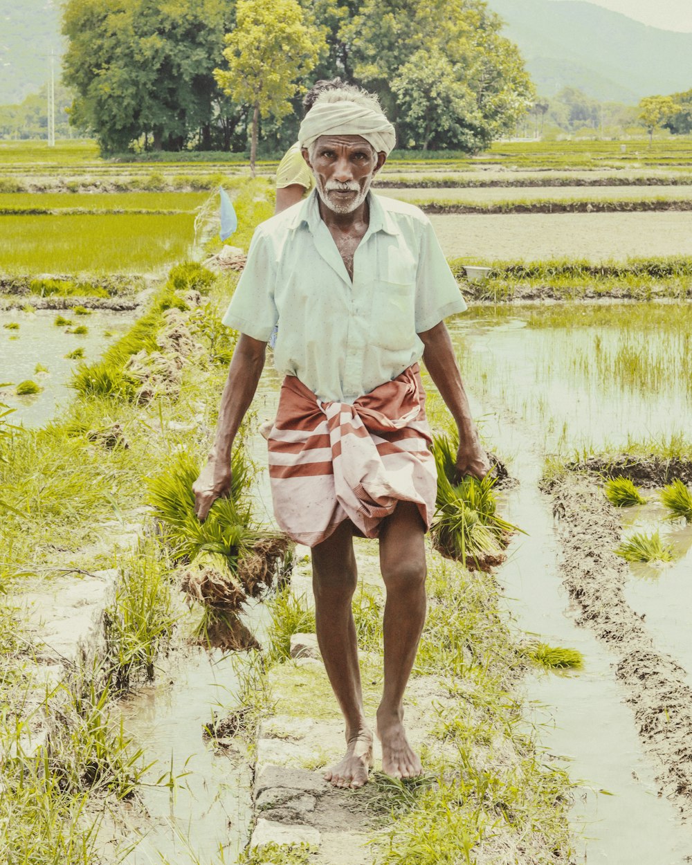 a man is standing in a field with grass