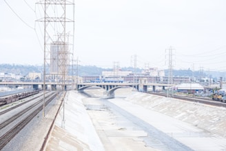 Rendering of a modern drainage system including canals and galleries in an industrial area.