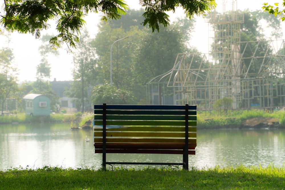 a park bench sitting next to a body of water