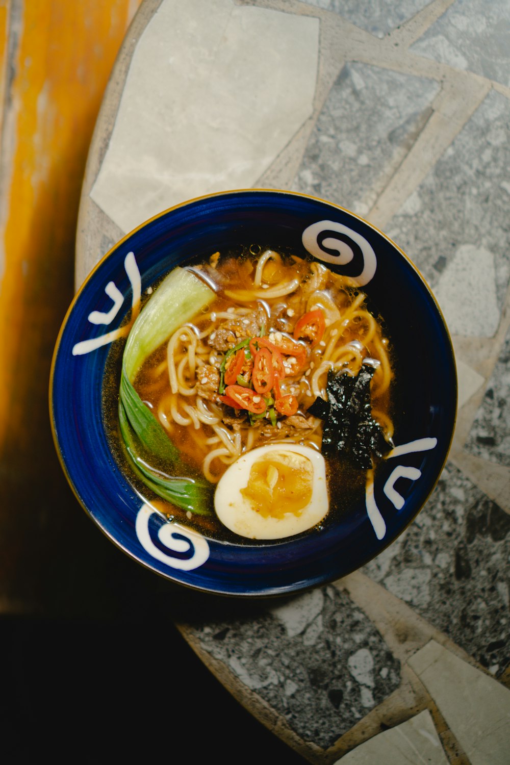 a bowl of ramen with an egg on top