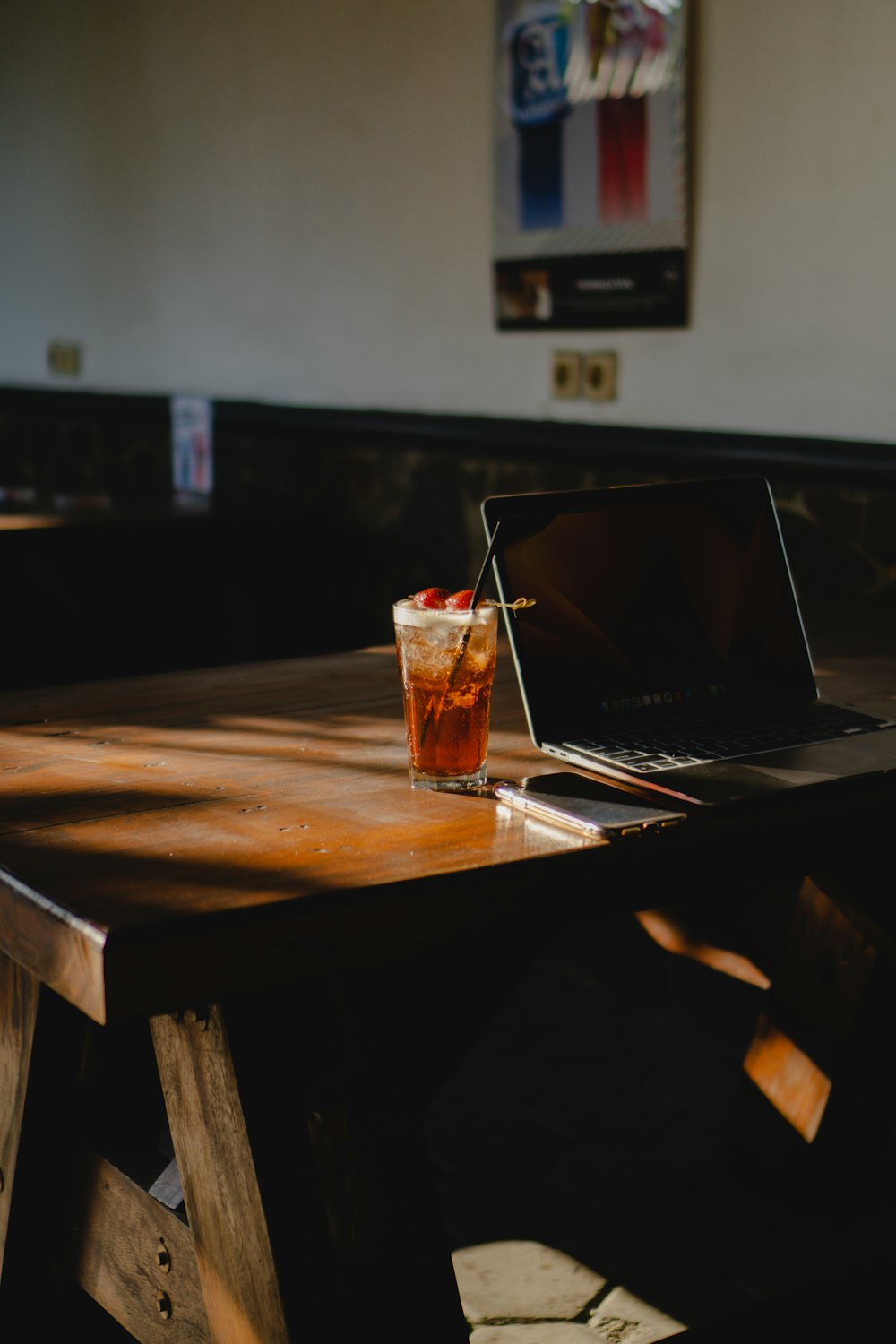 a laptop computer sitting on top of a wooden table