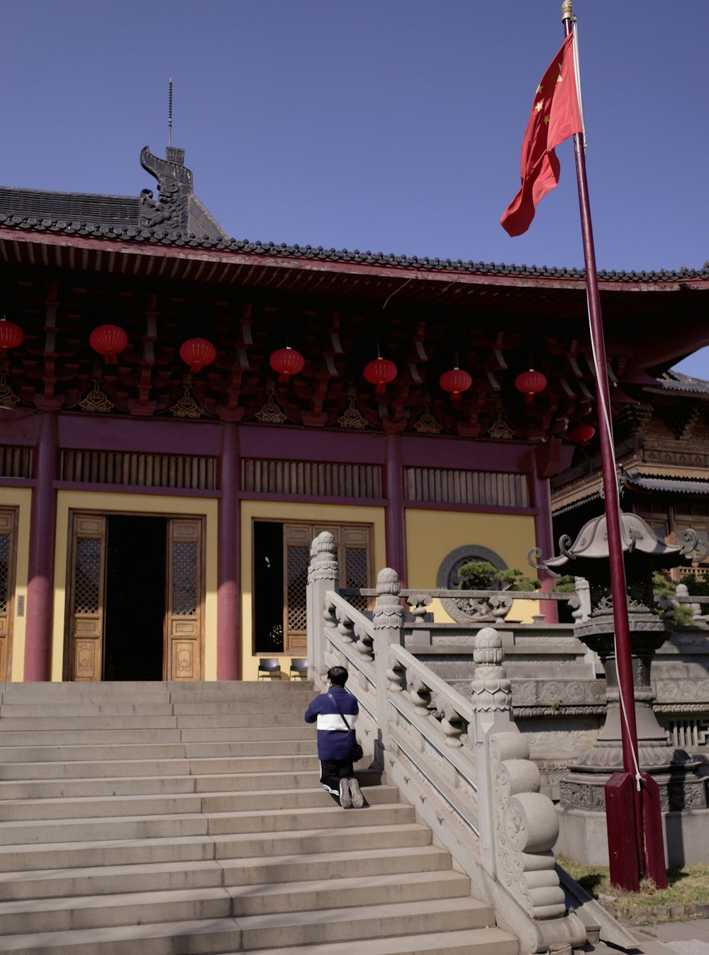 a person sitting on the steps in front of a building