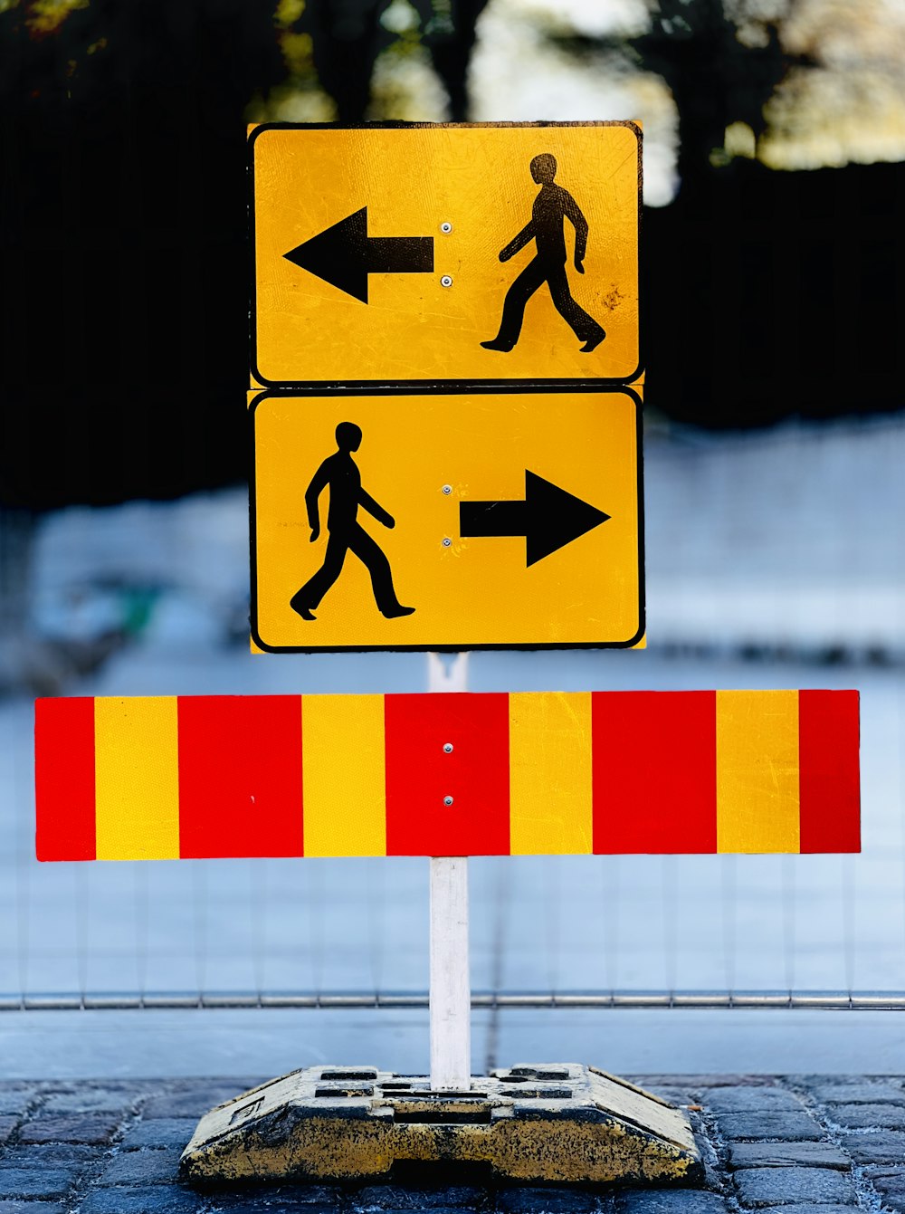 a pedestrian crossing sign on the side of the road