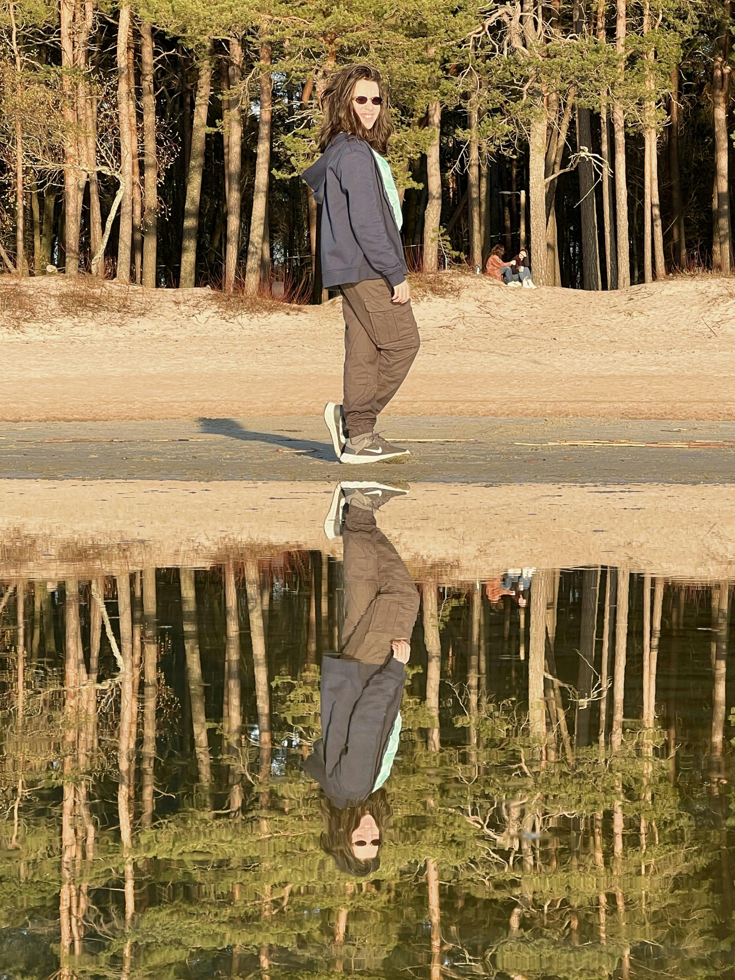 Reflection of face in still water creating mirror image