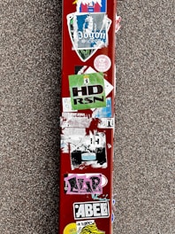 A close-up of vibrant, glossy resin stickers featuring custom designs on a laptop surface.