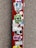 A red surface is covered with multiple colorful stickers, including logos, text, and designs. The background is a textured gray surface.