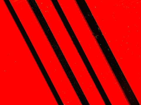 A bold, sharp esports logo design with red and black colors.