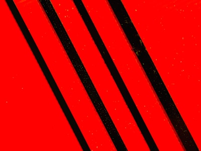 A striking artwork by Hannes Zebedin featuring bold red and black contrasts inspired by the Albanian flag.