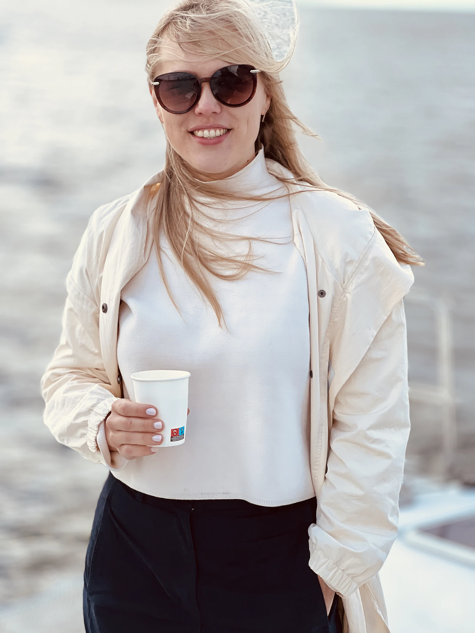 Woman in sunglasses enjoying a bright day at the beach