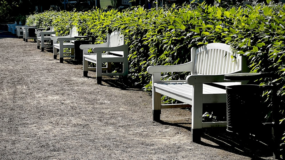 a row of white benches sitting next to each other