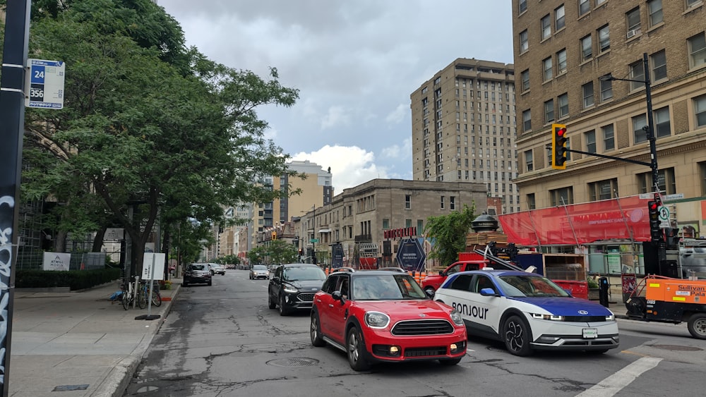 a city street filled with traffic next to tall buildings