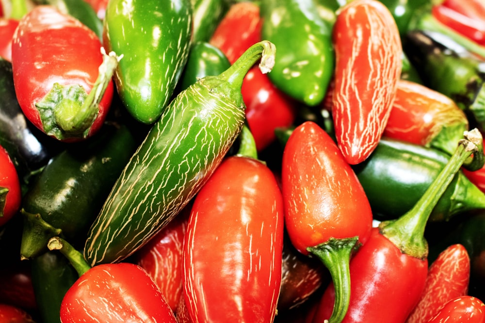 a pile of red, green and yellow peppers