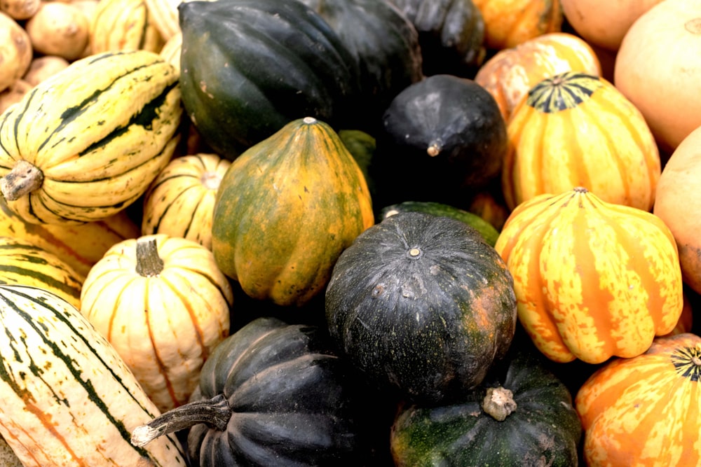 a pile of different types of squash on display