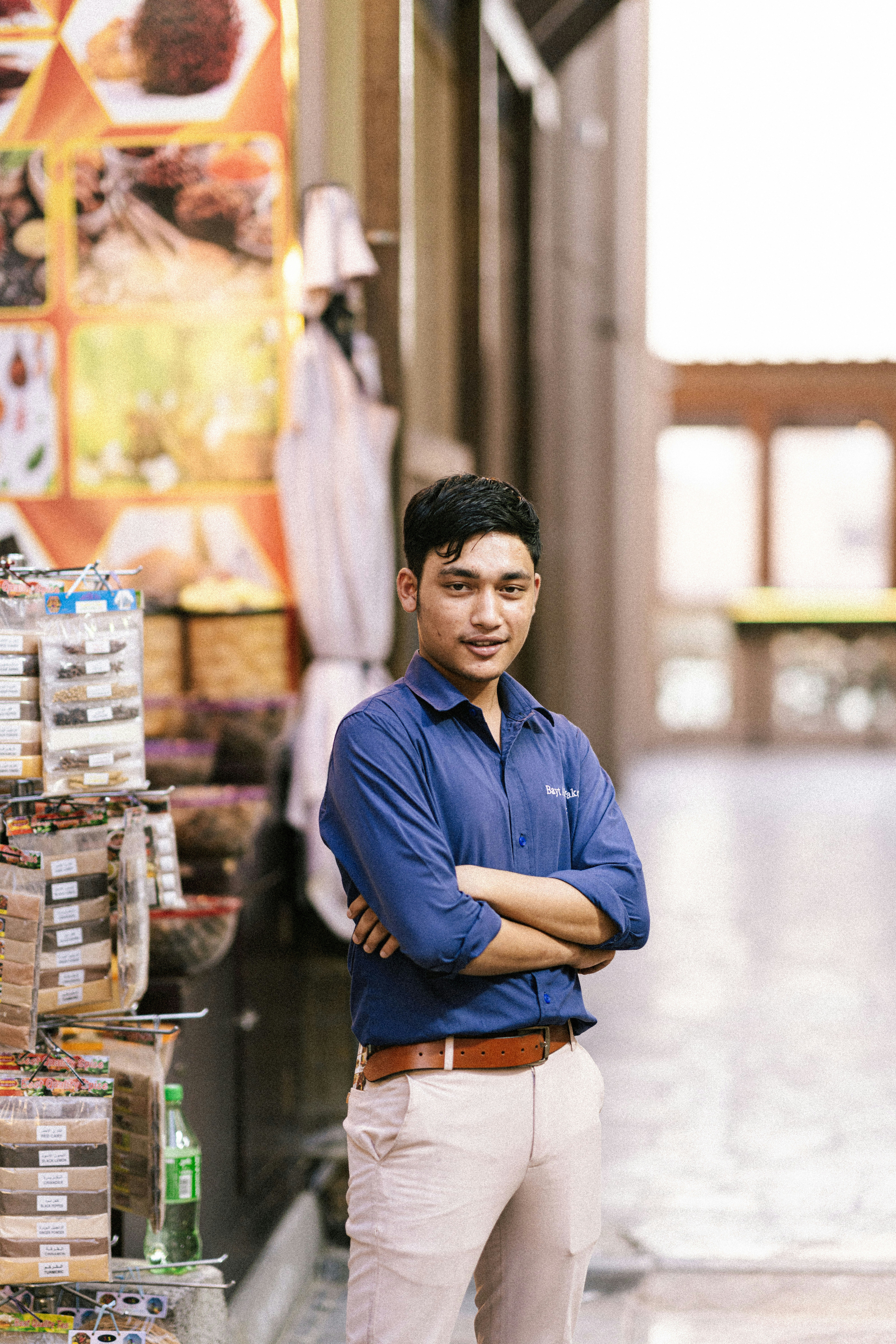 a man standing in a store with his arms crossed