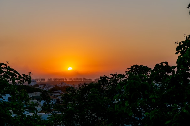 A vibrant sunset over a city skyline symbolizing progress.