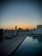 A relaxed guest enjoying a view from the rooftop pool of Efcee Sarovar Premiere at sunset.