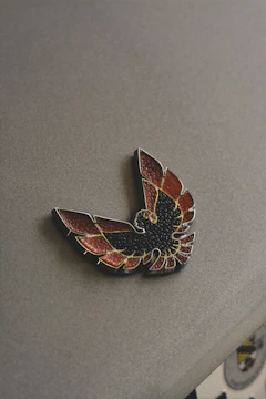 An elegant badge icon with a star, glowing in bold red and black tones, representing leadership.