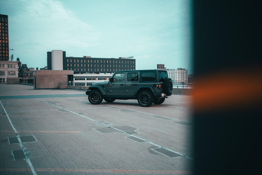 a black jeep is parked in a parking lot