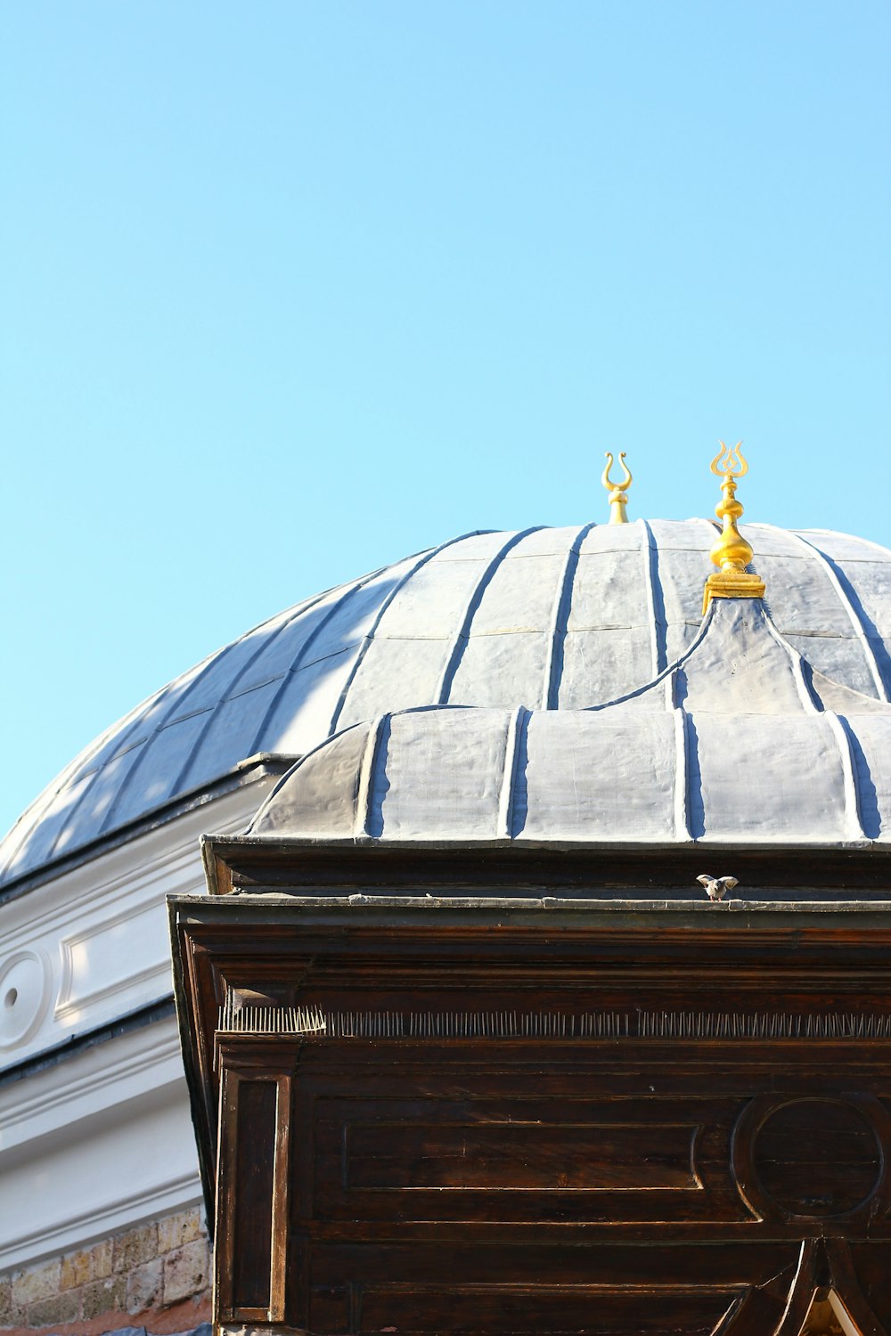 a large dome with a gold statue on top of it