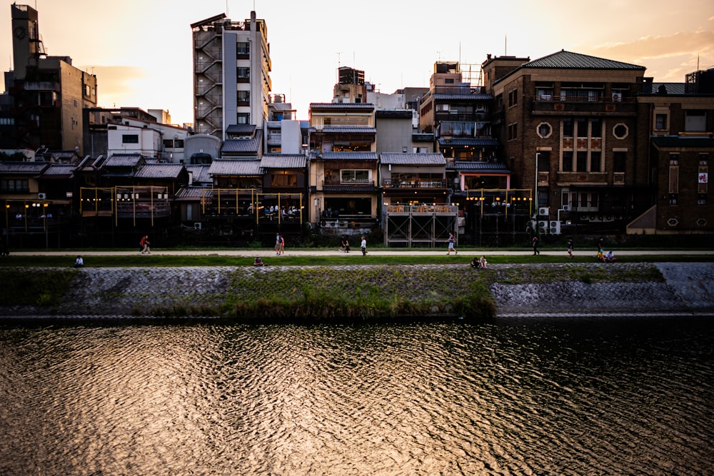 a body of water with buildings in the background