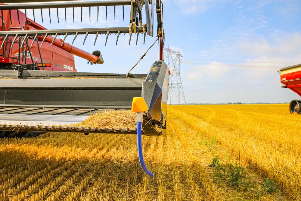 a combine of grain being loaded onto a truck