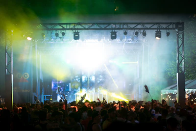 A vibrant travel scene with a group enjoying a scenic outdoor concert.