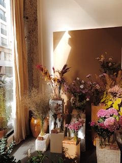 An elegant assortment of glass vases filled with fresh flowers in a bright room.