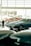 Several classic sports cars are displayed in what appears to be a showroom with large windows. The cars have sleek, vintage designs, and the lighting creates a reflective surface on the polished floor.
