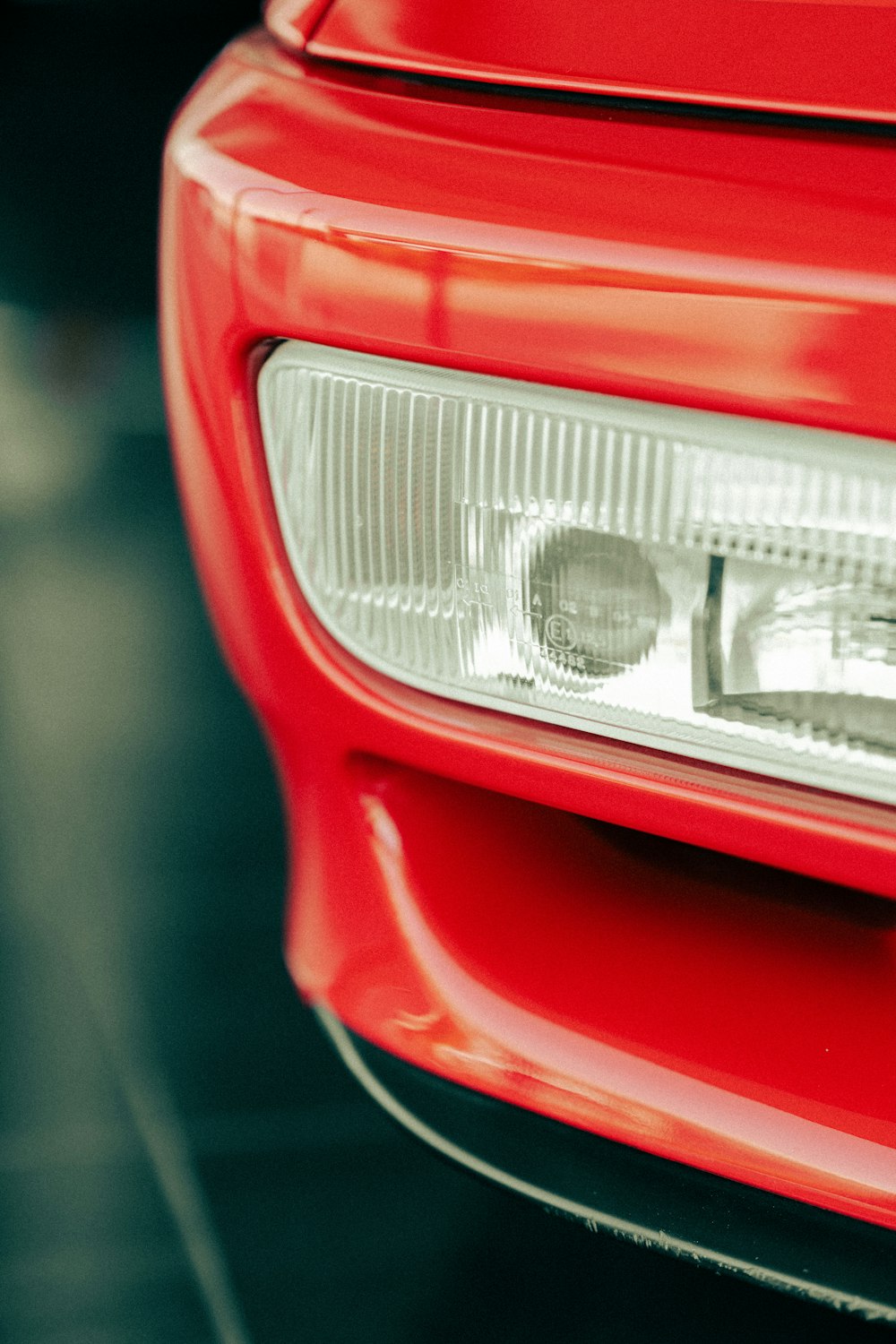 a close up of the front of a red car