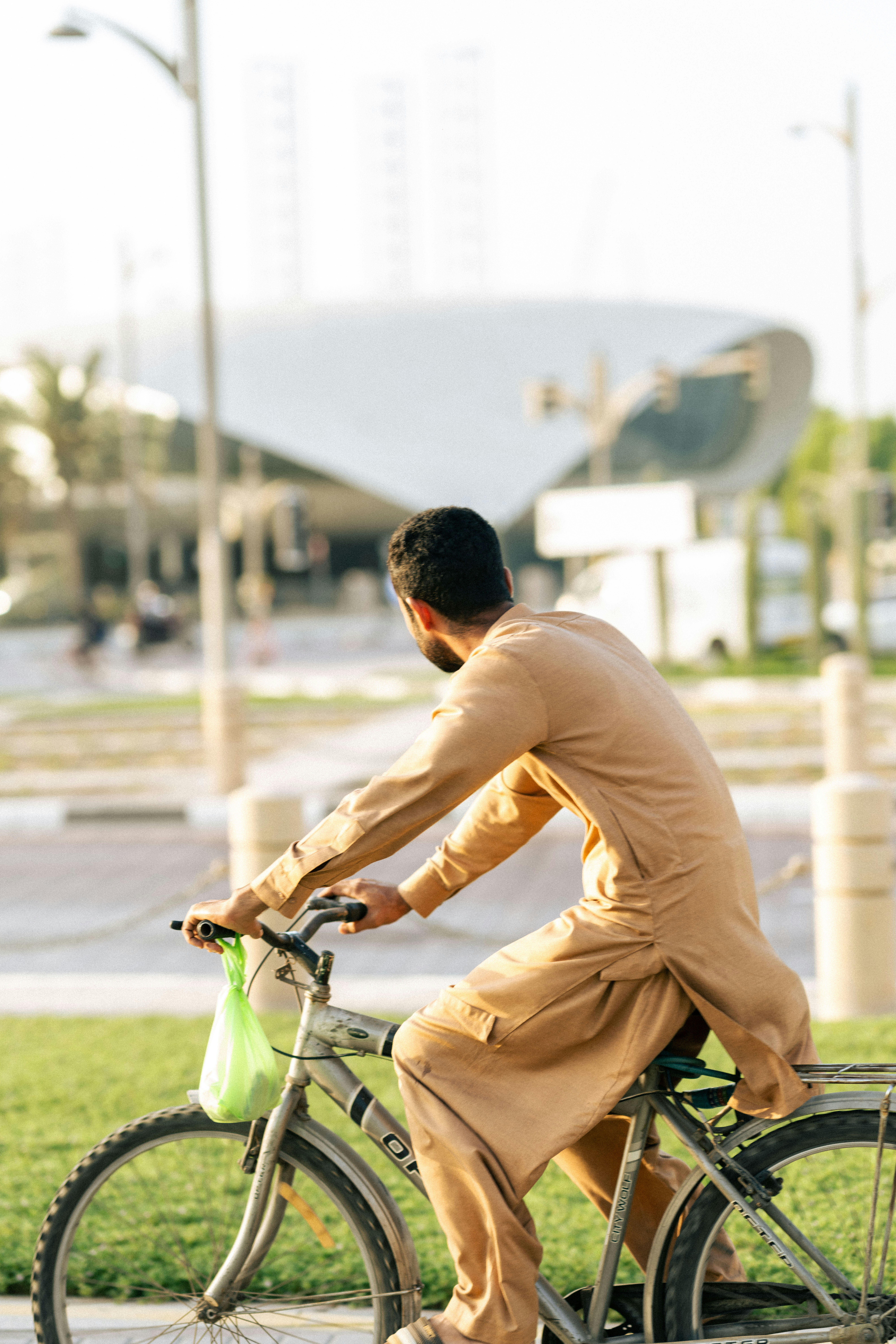 a man riding a bike down a street