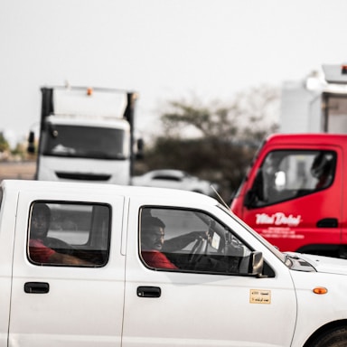 A friendly dispatcher speaking on the phone with a truck driver in the background.