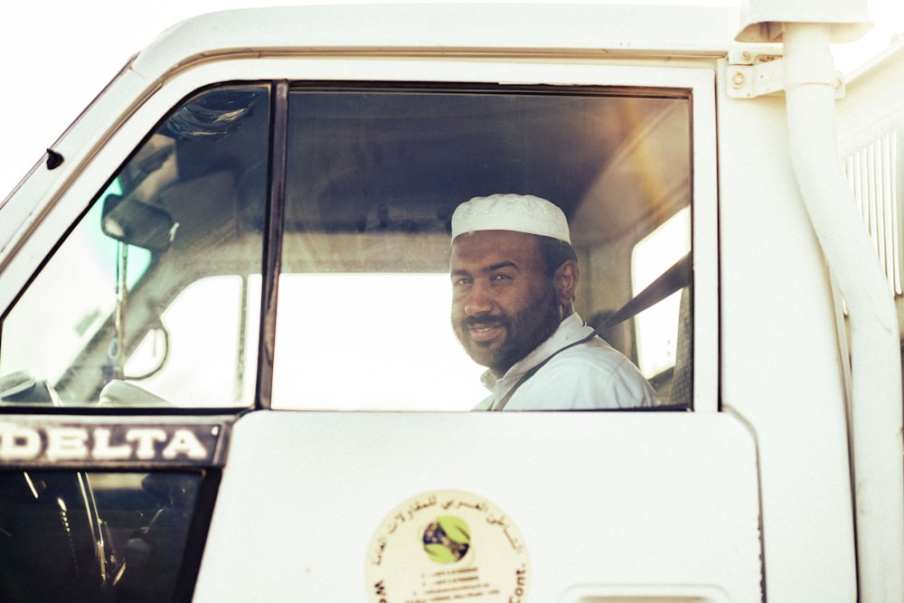 a man sitting in the drivers seat of a truck
