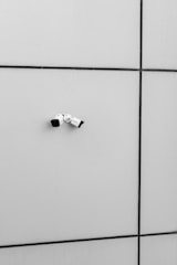 a black and white photo of a bathroom wall